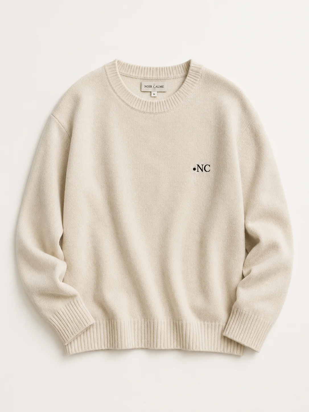Lambswool knit in bone with the •NC monogram embroidered in black